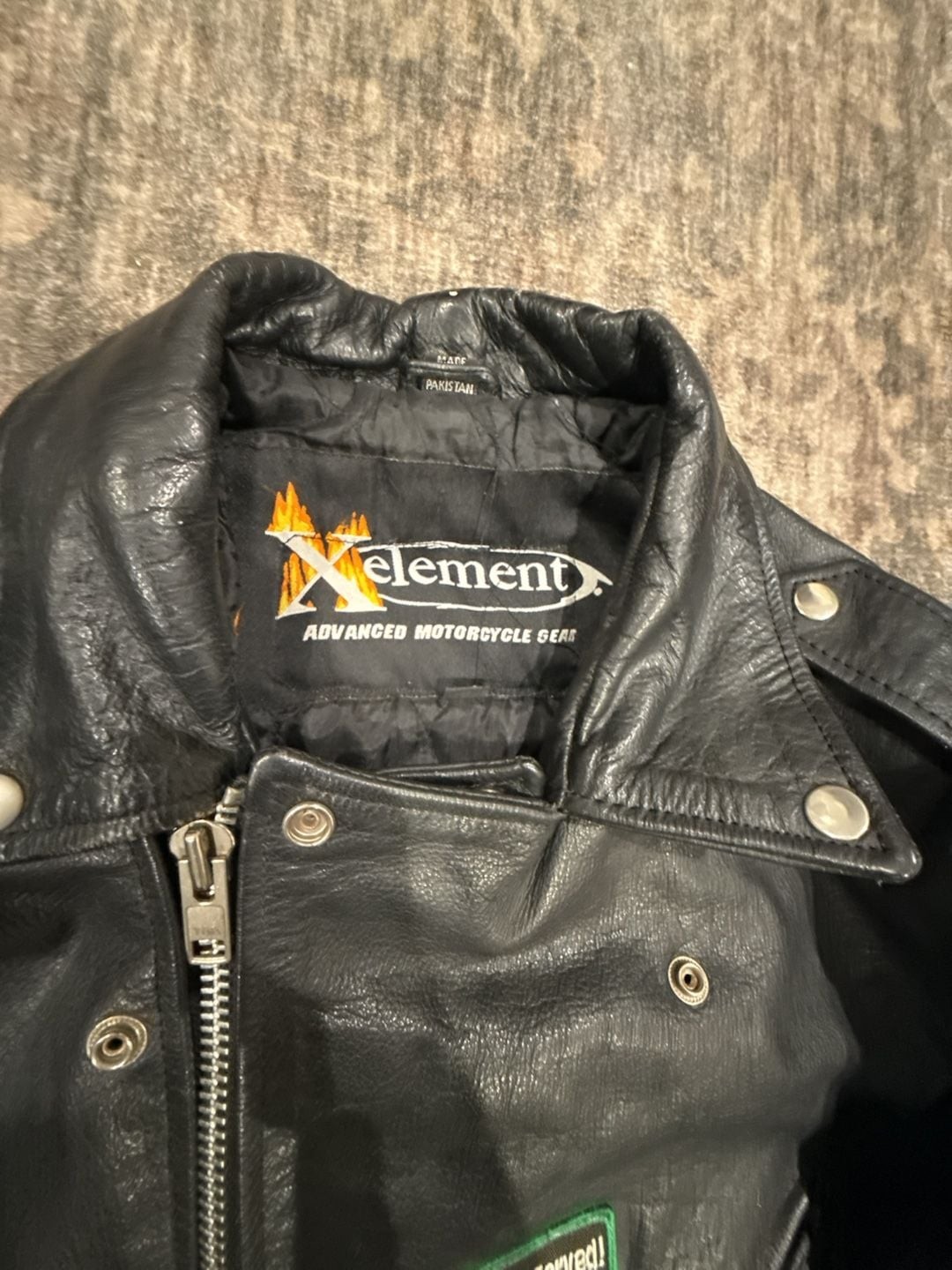 Xelement Men’s Leather Motorcycle Jacket with Veteran and Biker Patches