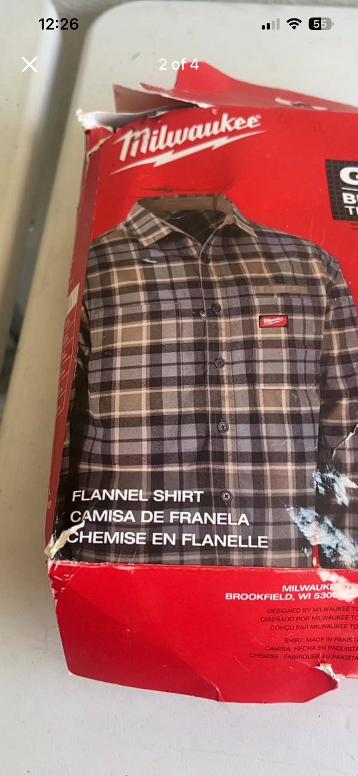 Gray plaid flannel shirt. Shirt is size L. It is new in original packaging.