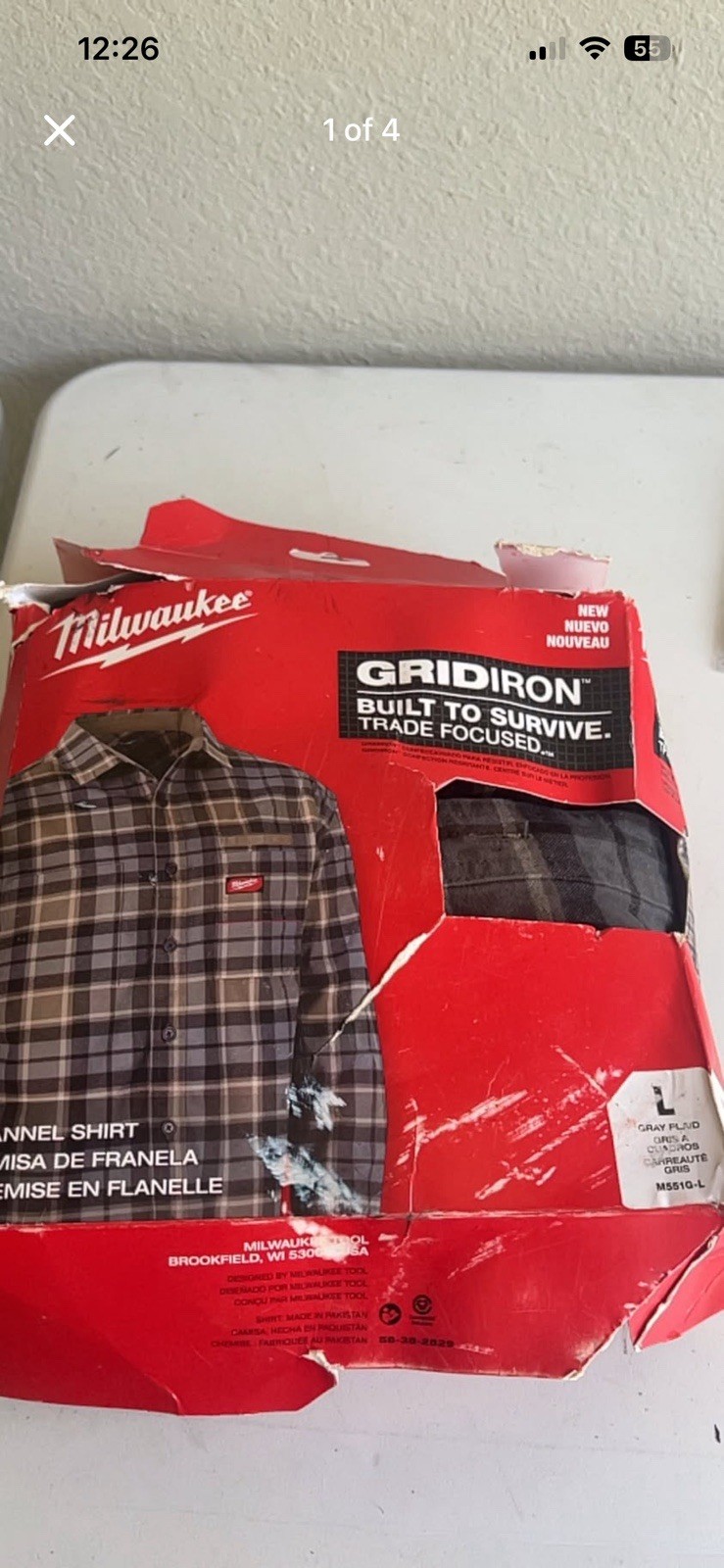 Gray plaid flannel shirt. Shirt is size L. It is new in original packaging.