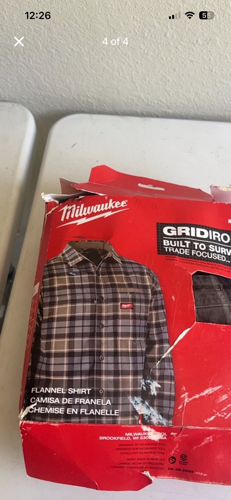 Gray plaid flannel shirt. Shirt is size L. It is new in original packaging.